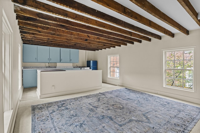 below grade area featuring fridge and light colored carpet