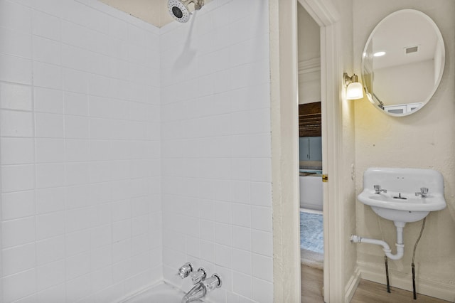 bathroom with visible vents and shower / bath combination