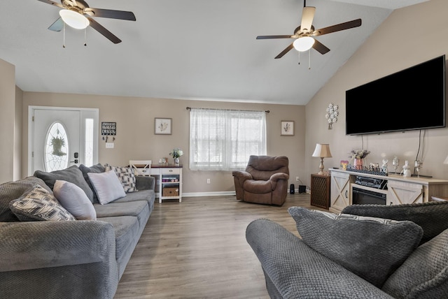 living area featuring a ceiling fan, healthy amount of natural light, light wood-style floors, and high vaulted ceiling