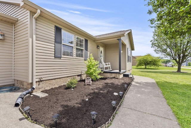 view of side of property featuring crawl space and a lawn