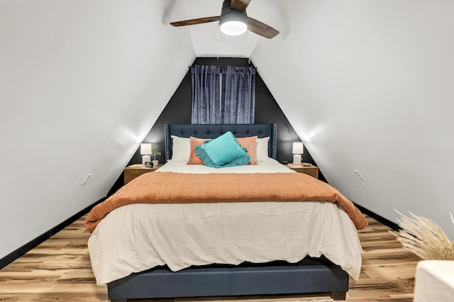 bedroom with baseboards, wood finished floors, ceiling fan, and vaulted ceiling