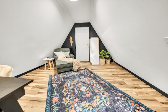 sitting room with lofted ceiling, wood finished floors, and baseboards