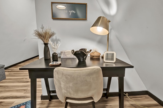 dining area featuring wood finished floors and baseboards