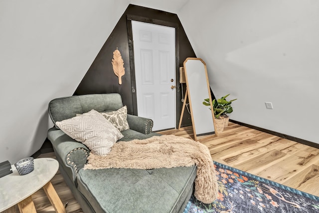 sitting room with lofted ceiling, wood finished floors, and baseboards