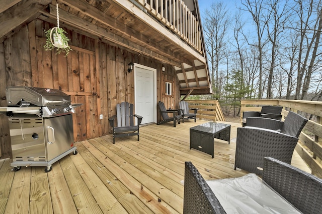 deck with area for grilling and an outdoor living space