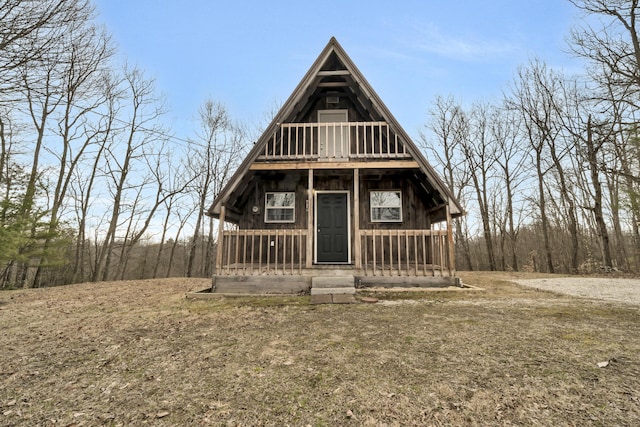view of front of house featuring covered porch and a balcony