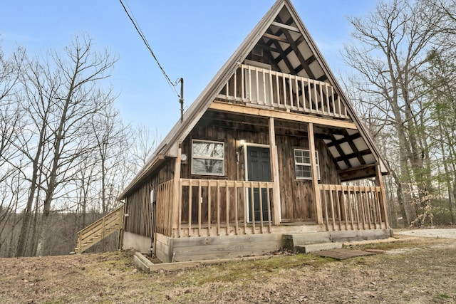 back of property featuring board and batten siding and stairs