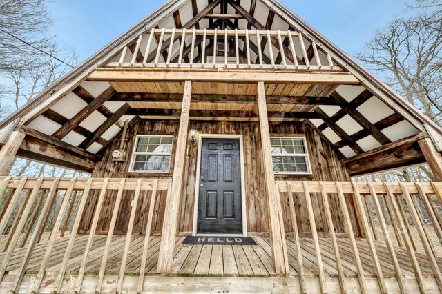 doorway to property featuring a deck and fence