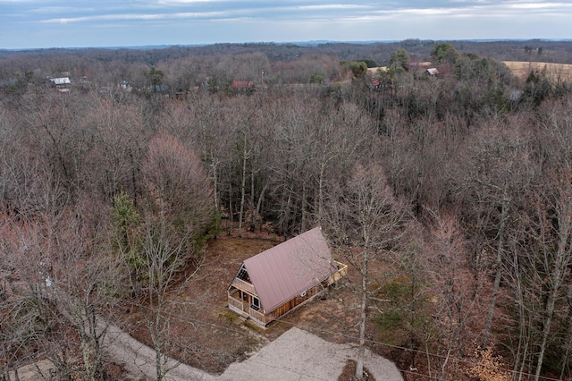 bird's eye view with a wooded view
