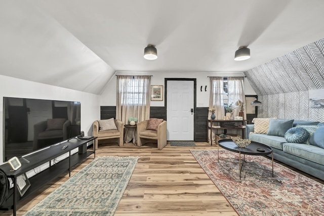 living room featuring vaulted ceiling and wood finished floors