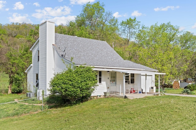 13955 Swallowfield Rd, Frankfort, KY 40601 - rear view of property featuring a yard, cooling unit, roof with shingles, and covered porch