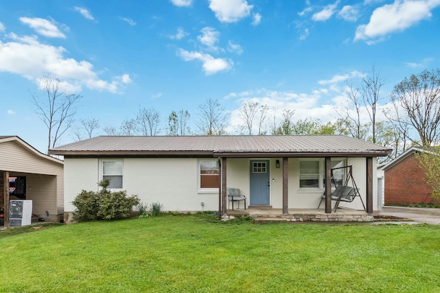 single story home with a porch, brick siding, a front yard, and metal roof