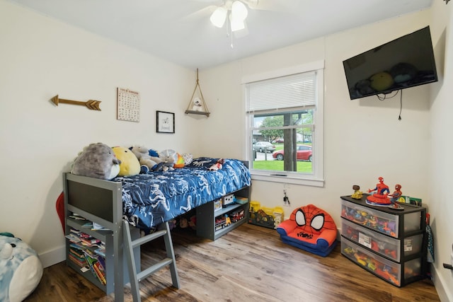 bedroom with ceiling fan and wood finished floors