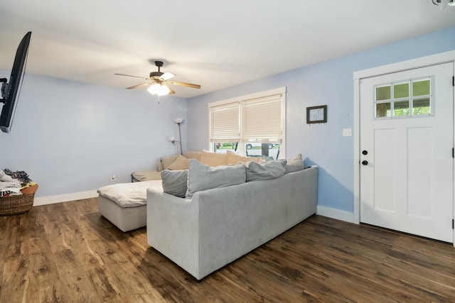living area featuring baseboards, plenty of natural light, dark wood-style floors, and ceiling fan