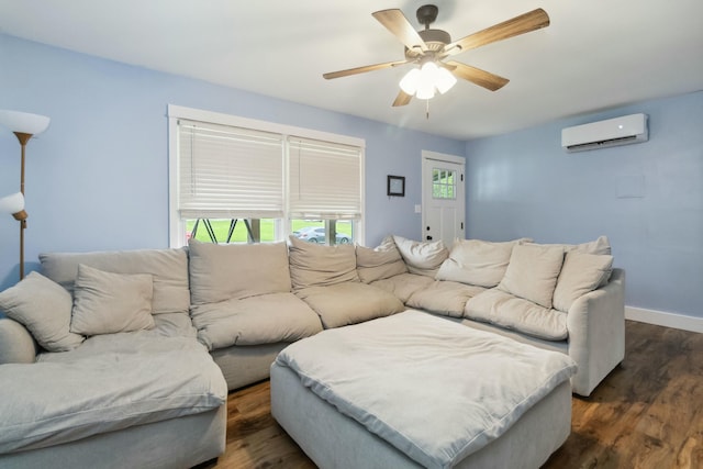 living area featuring dark wood finished floors, a wall mounted air conditioner, a ceiling fan, and baseboards