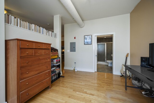 650 S Mill St Unit 219, Lexington, KY 40508 - bedroom with ensuite bath, baseboards, electric panel, and light wood-style flooring