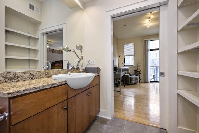 650 S Mill St Unit 219, Lexington, KY 40508 - bathroom with a ceiling fan, visible vents, tile patterned flooring, and vanity
