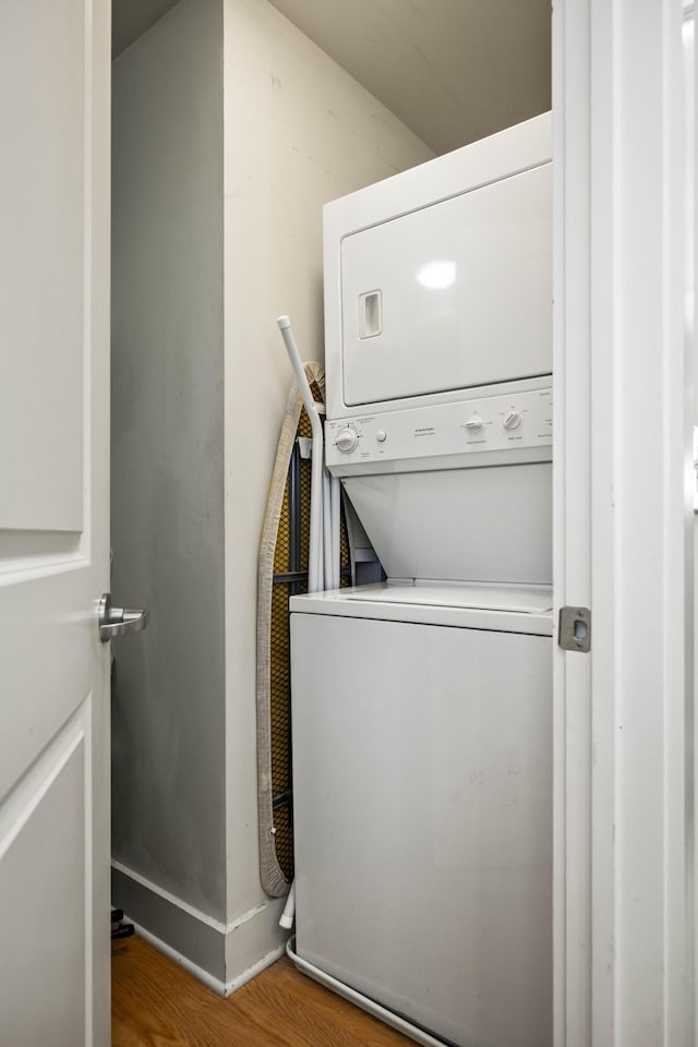 650 S Mill St Unit 219, Lexington, KY 40508 - laundry area with stacked washer and dryer, wood finished floors, and laundry area
