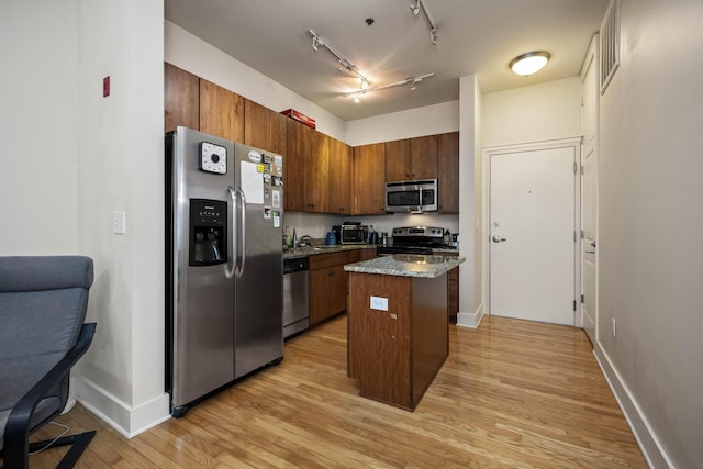 650 S Mill St Unit 219, Lexington, KY 40508 - kitchen with light wood finished floors, stainless steel appliances, a center island, baseboards, and track lighting