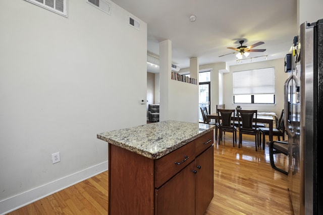 650 S Mill St Unit 219, Lexington, KY 40508 - kitchen featuring light wood-type flooring, baseboards, freestanding refrigerator, visible vents, and a ceiling fan