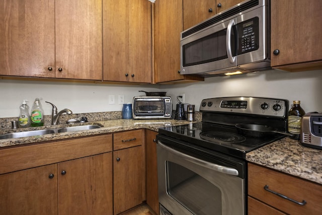 650 S Mill St Unit 219, Lexington, KY 40508 - kitchen featuring brown cabinets, appliances with stainless steel finishes, and a sink