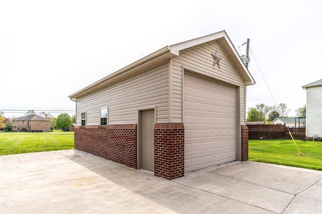 detached garage featuring fence