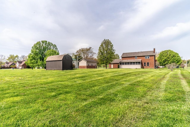 view of yard featuring a garage, an outdoor structure, and a shed