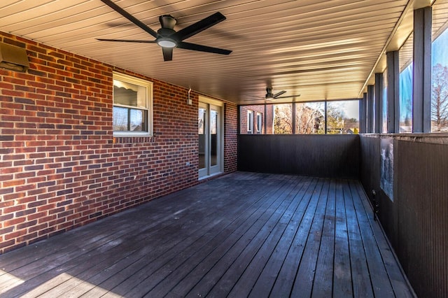 unfurnished sunroom with ceiling fan and plenty of natural light