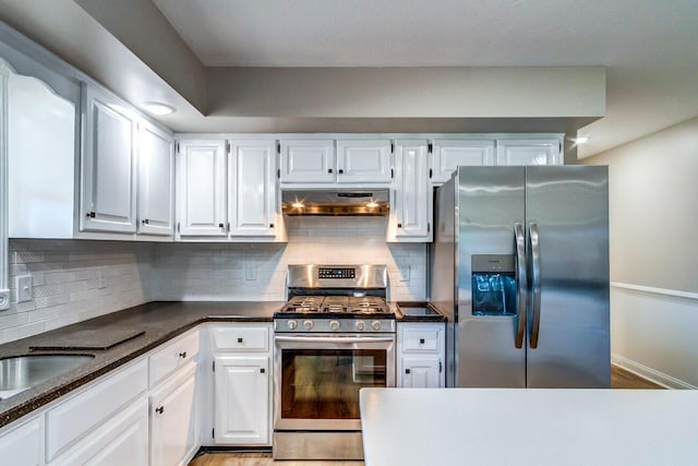 kitchen featuring stainless steel appliances, backsplash, exhaust hood, and white cabinetry