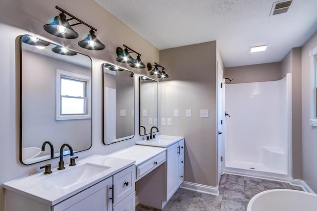 full bathroom featuring visible vents, a walk in shower, baseboards, and a sink