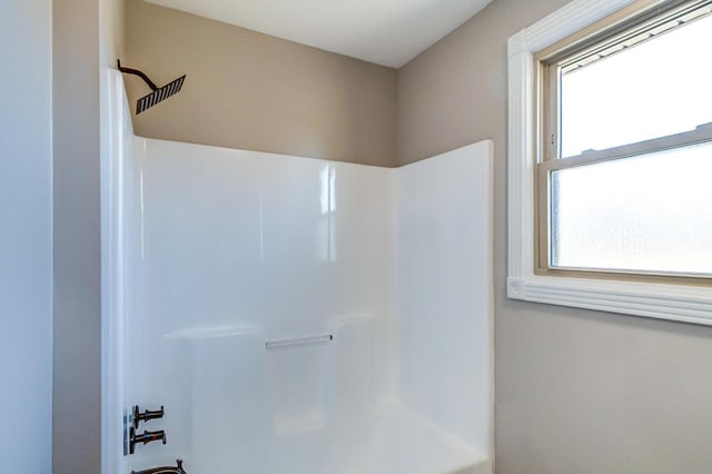 bathroom with shower / bathtub combination and a wealth of natural light