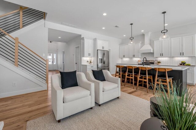4137 Meadowlark Rd, Lexington, KY 40509 - living room with recessed lighting, stairway, visible vents, and light wood finished floors