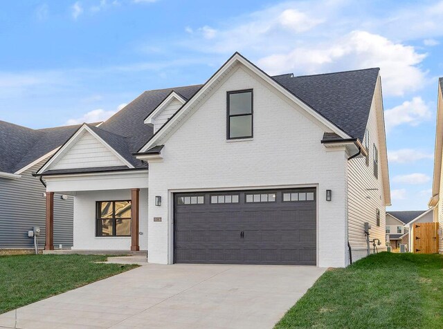 4137 Meadowlark Rd, Lexington, KY 40509 - modern farmhouse style home featuring driveway, brick siding, a front yard, and a garage