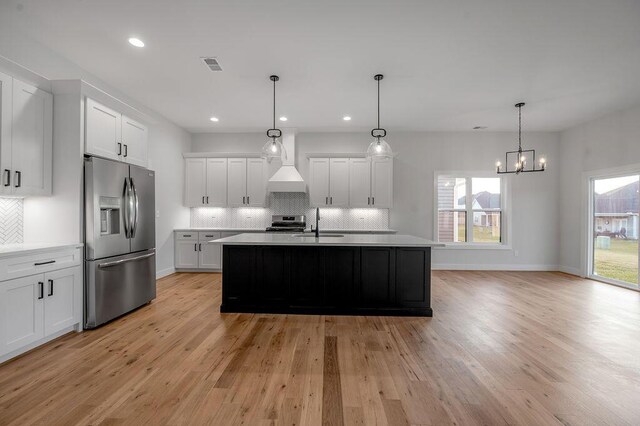 4137 Meadowlark Rd, Lexington, KY 40509 - kitchen with decorative backsplash, light wood-style floors, stainless steel appliances, light countertops, and visible vents