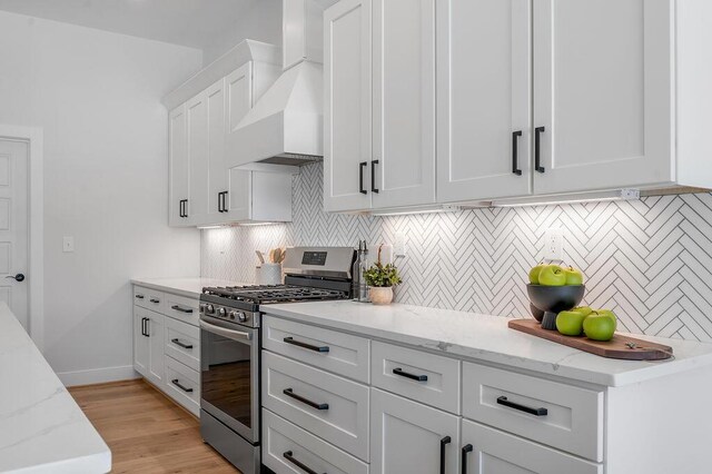 4137 Meadowlark Rd, Lexington, KY 40509 - kitchen featuring premium range hood, white cabinets, tasteful backsplash, and stainless steel gas stove