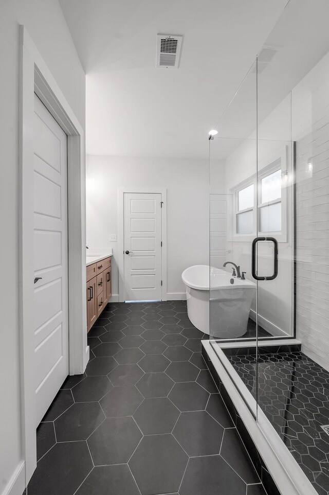 4137 Meadowlark Rd, Lexington, KY 40509 - full bathroom featuring a shower stall, tile patterned floors, vanity, a soaking tub, and visible vents