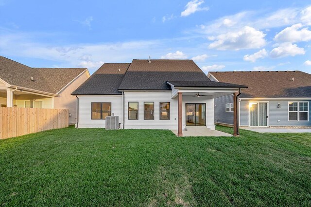4137 Meadowlark Rd, Lexington, KY 40509 - back of property with central AC, fence, a ceiling fan, a lawn, and a patio
