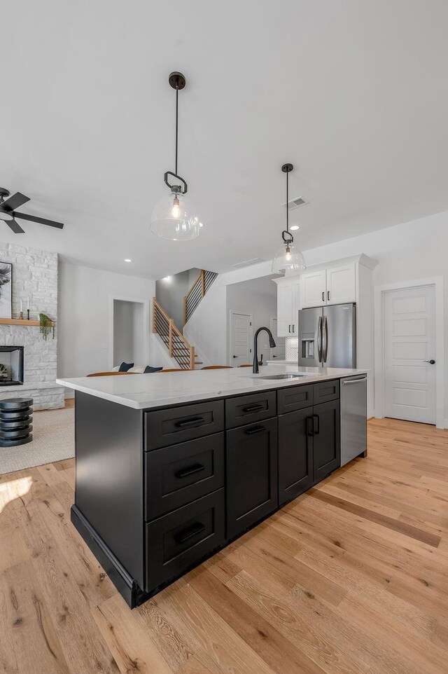 4137 Meadowlark Rd, Lexington, KY 40509 - kitchen with a sink, light wood finished floors, light countertops, white cabinets, and appliances with stainless steel finishes