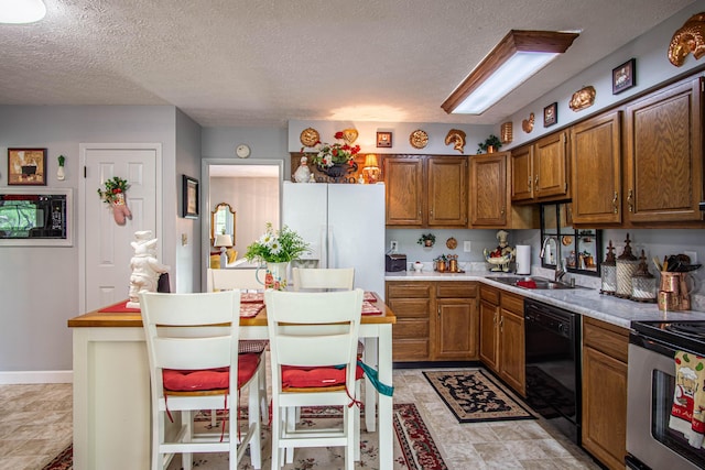 kitchen with a sink, black dishwasher, brown cabinets, light countertops, and electric stove