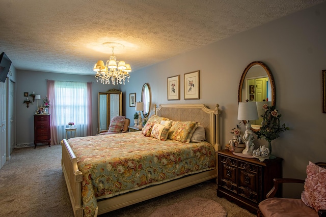 bedroom with carpet floors, a notable chandelier, and a textured ceiling