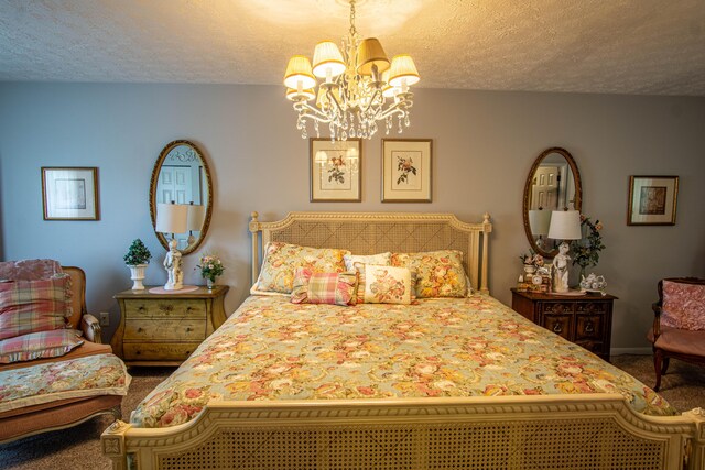 bedroom featuring baseboards, carpet floors, a textured ceiling, and an inviting chandelier