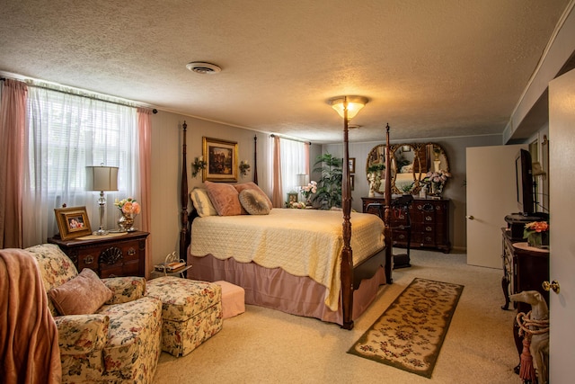 bedroom with a textured ceiling, visible vents, and light colored carpet