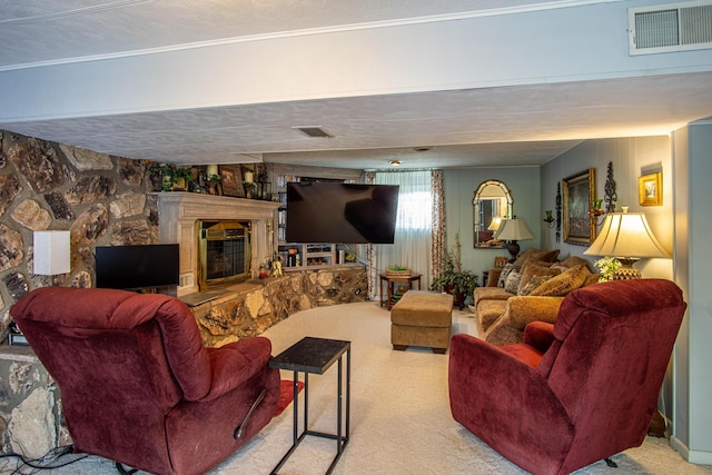 carpeted living area featuring a glass covered fireplace and visible vents