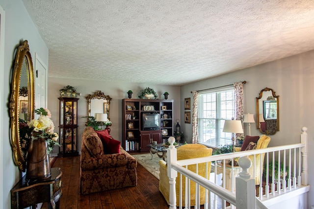 living room with hardwood / wood-style floors and a textured ceiling