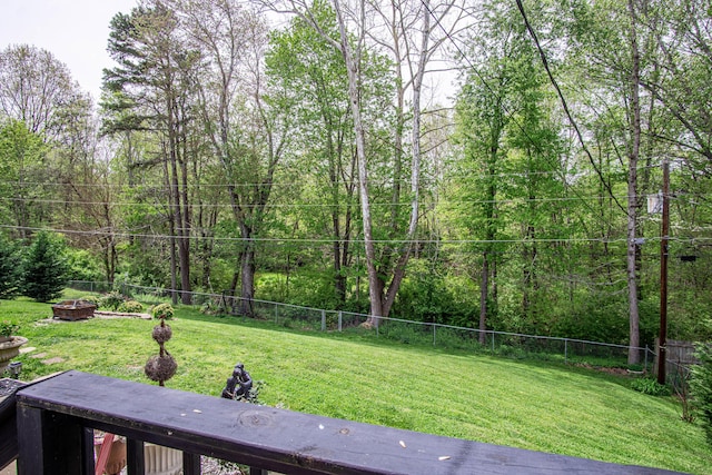 view of yard with a fenced backyard and a forest view