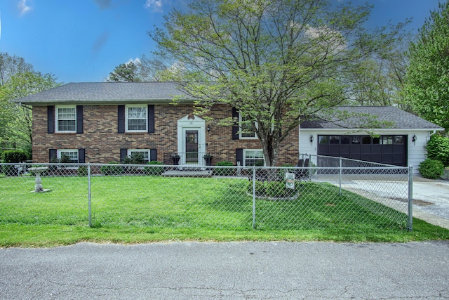 split foyer home with brick siding, driveway, a garage, and a fenced front yard