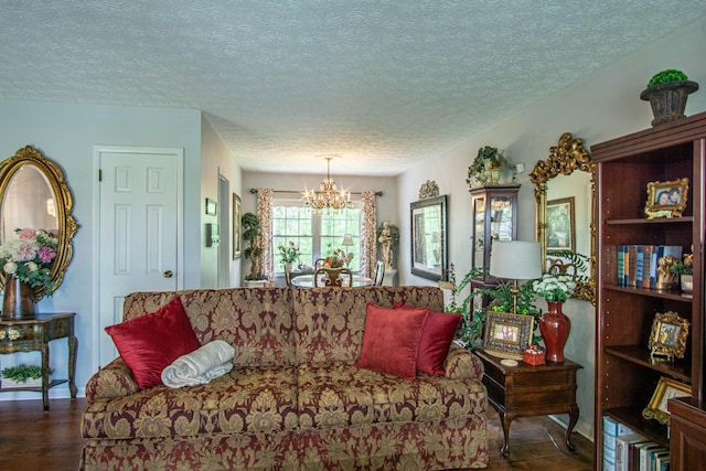 living area with wood finished floors, a chandelier, and a textured ceiling