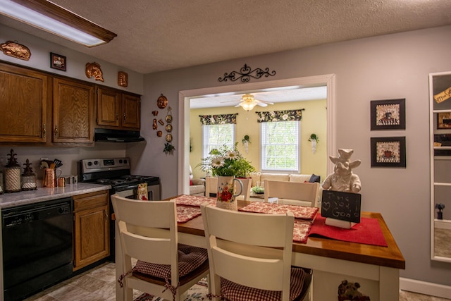 dining space featuring a ceiling fan and a textured ceiling