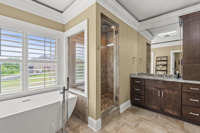 full bath featuring a shower stall, crown molding, vanity, a freestanding tub, and baseboards