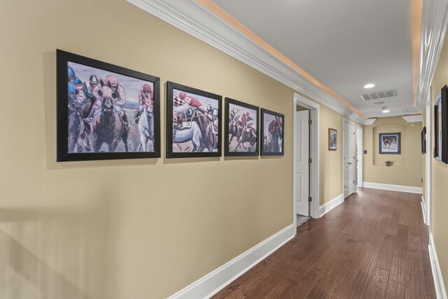 corridor with dark wood-type flooring, baseboards, ornamental molding, and recessed lighting